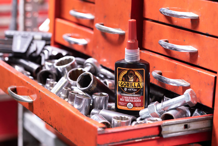 A photo of a bottle of GorillaPro AT160 red large thread threadlocker in a tool chest next to hand tools. (Product image)